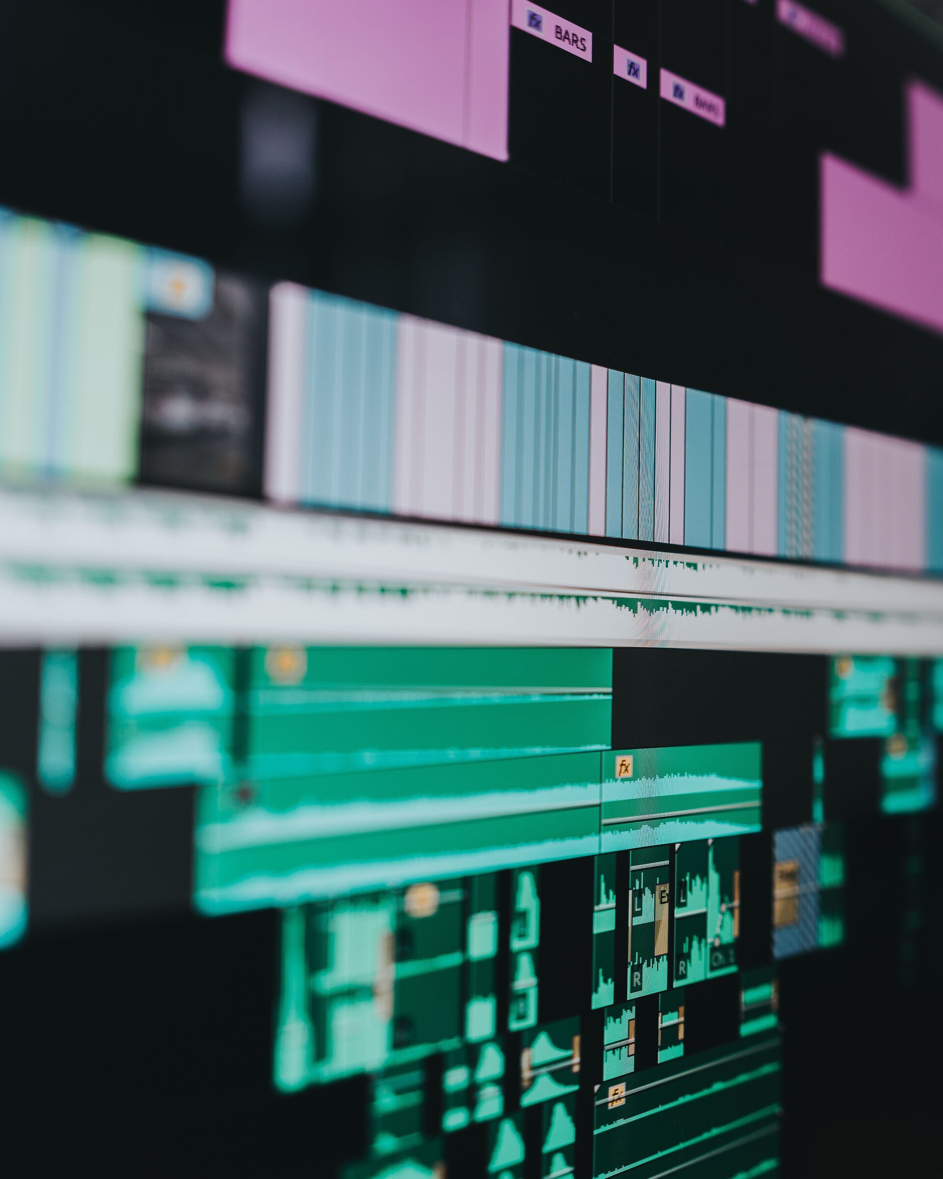 A close, abstract view of a color-coded video editing timeline.