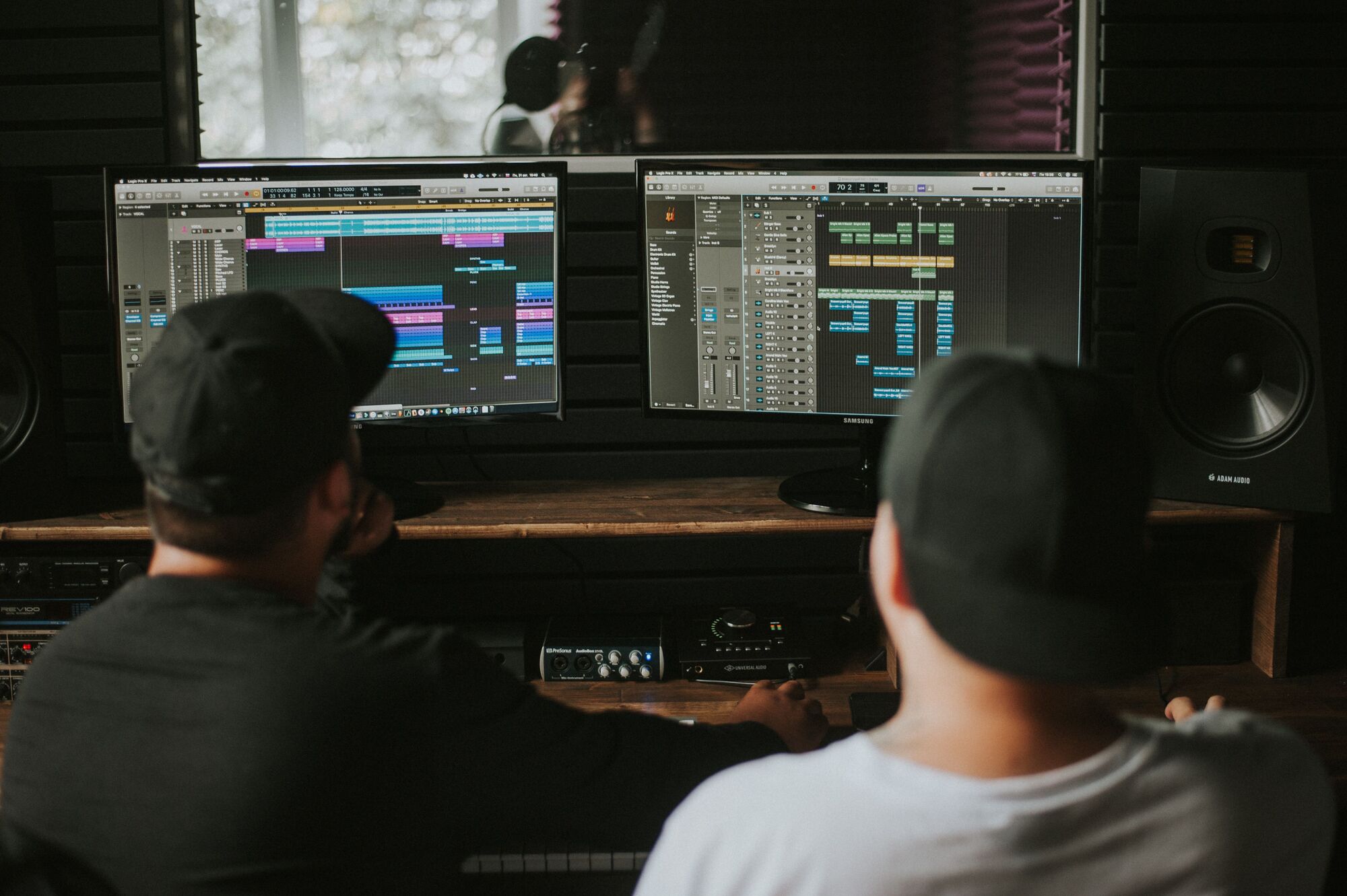 Two people work together at a music production session.